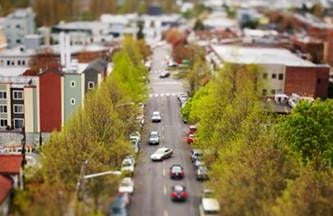 an arial view of a street with houses and cars