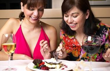 two women sharing dessert