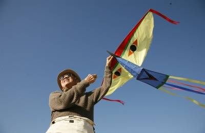 Animator Tyrus Wong flies one of his custom-made kites in a scene from HOW TO LI