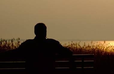 Depressed man watching the sunset