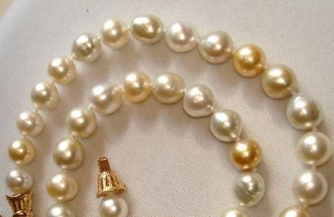 varied hues of gold, cream and white oval-shaped pearls