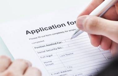 person filling out job application form