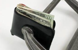 a wallet squeezed by a clamp