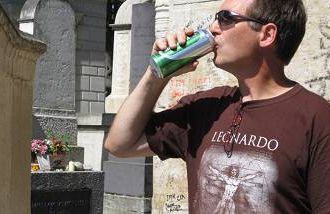 Darcy Rhyno drinks at Jim Morrison’s graveside at Pere Lachaise Cemetery, Paris