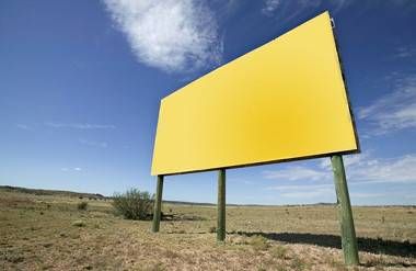 a yellow blank billboard in the desert