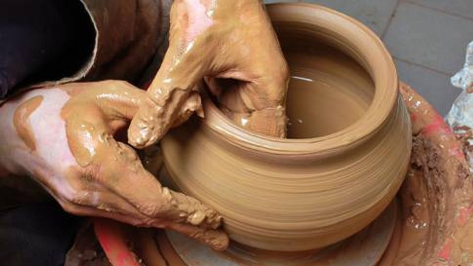 Person creating pottery