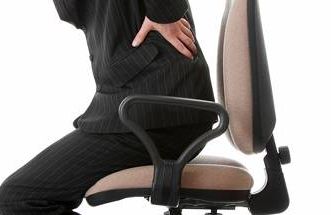 an officer worker with back pain in a desk chair