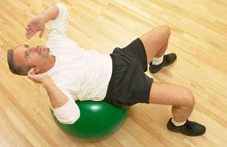 A man on a stability ball, great home gym equipment