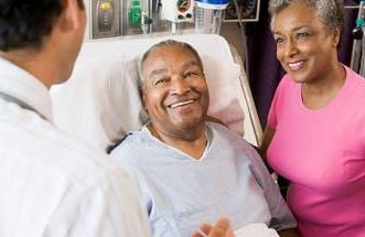 an african american couple in the hospital talking to a doctor