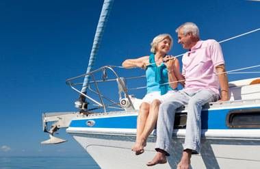Couple on vacation sitting on edge of boat