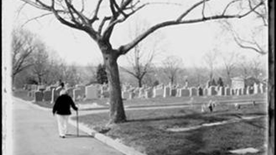 mary white walking in a cemetery