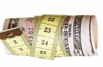 US dollars rolled up in a tape measure