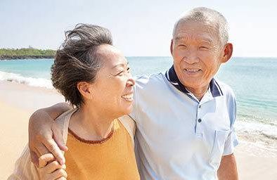 Retired couple walking on the beach