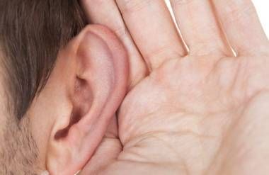 Person listening with hand by ear