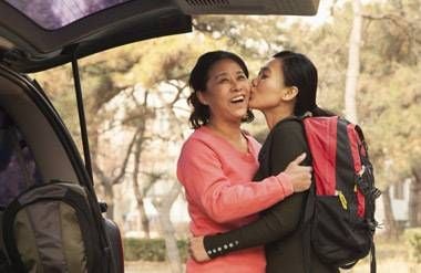Mother and daughter embracing as daughter goes to college