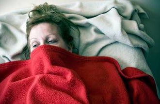 woman sick in bed