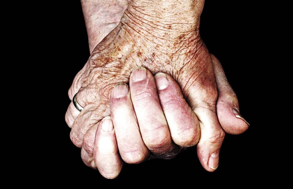 Older couple holding hands