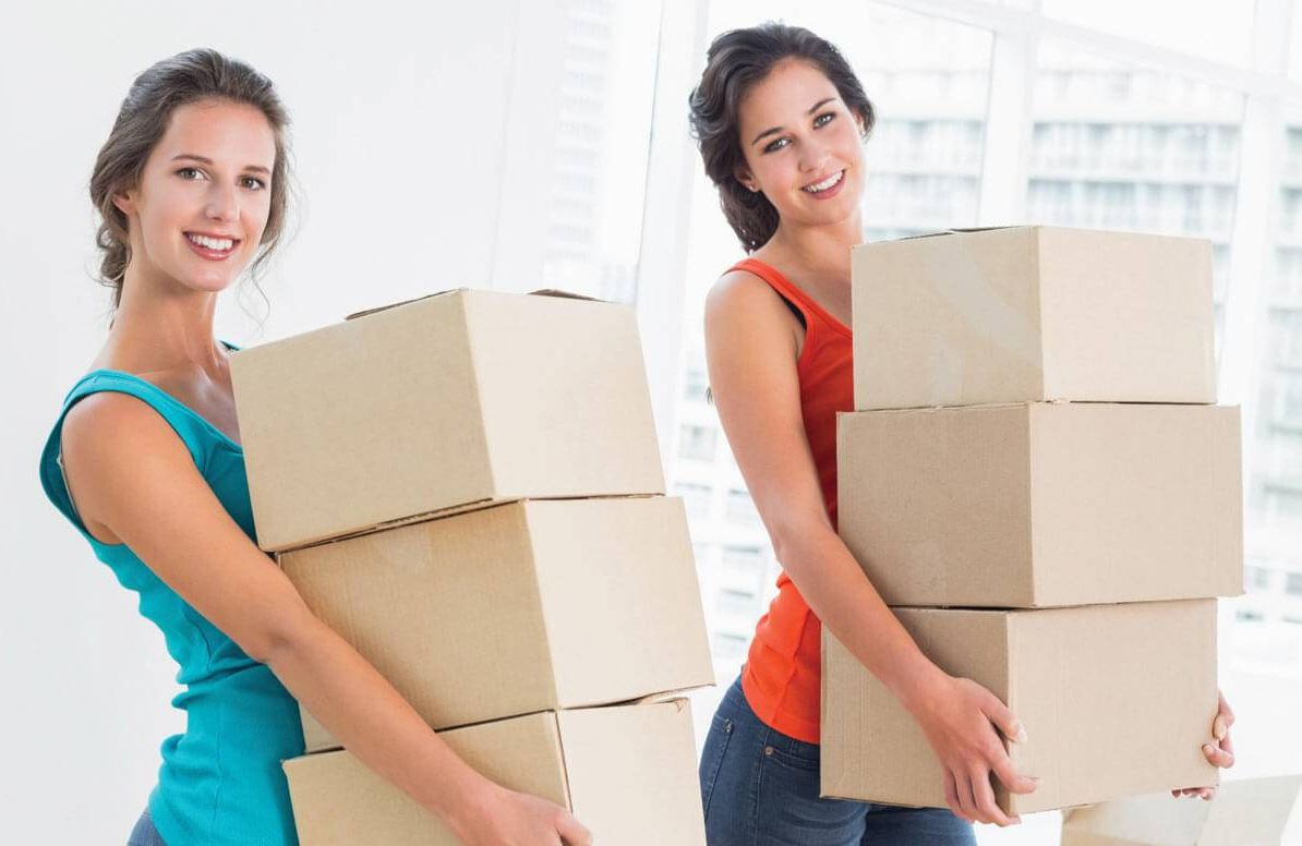 Two young adults with moving boxes