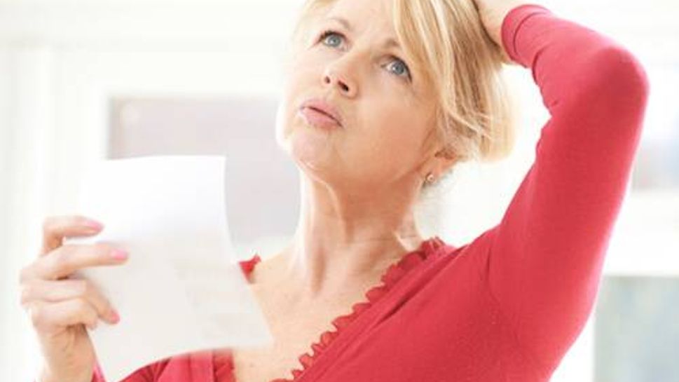 Mature Woman Experiencing Hot Flush From Menopause