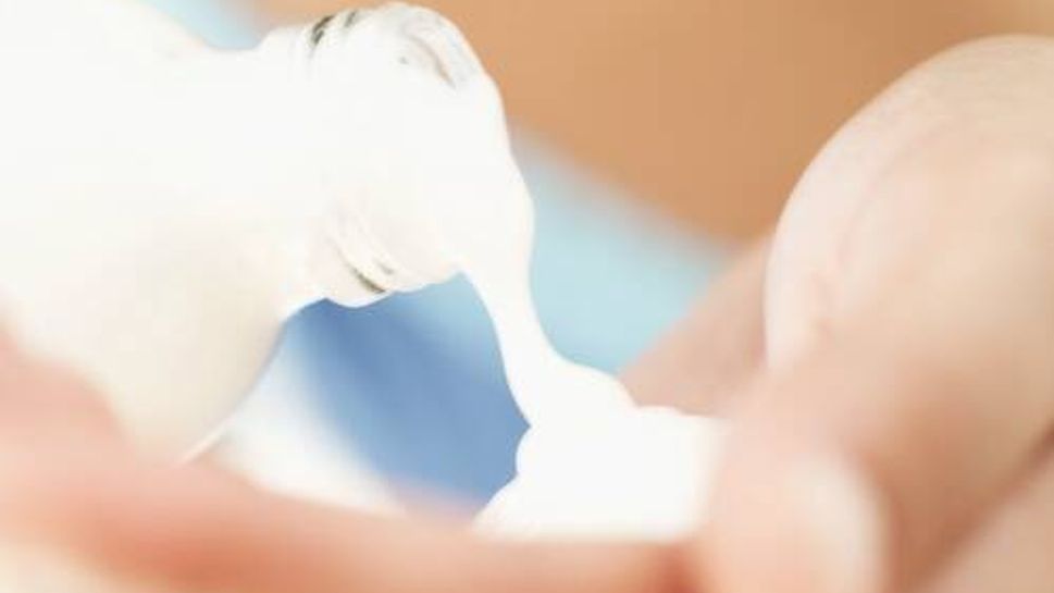 close-up of a person pouring lotion into the palm