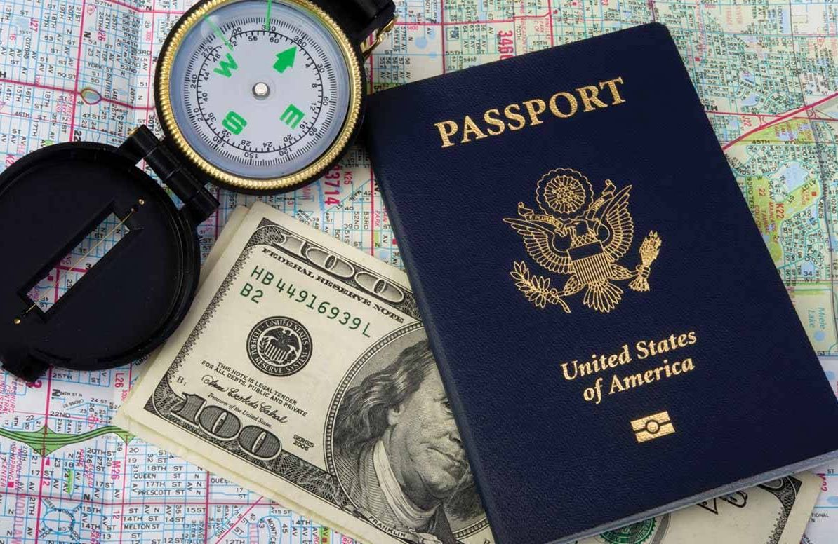 Collection of travel items passport, money, compass, map