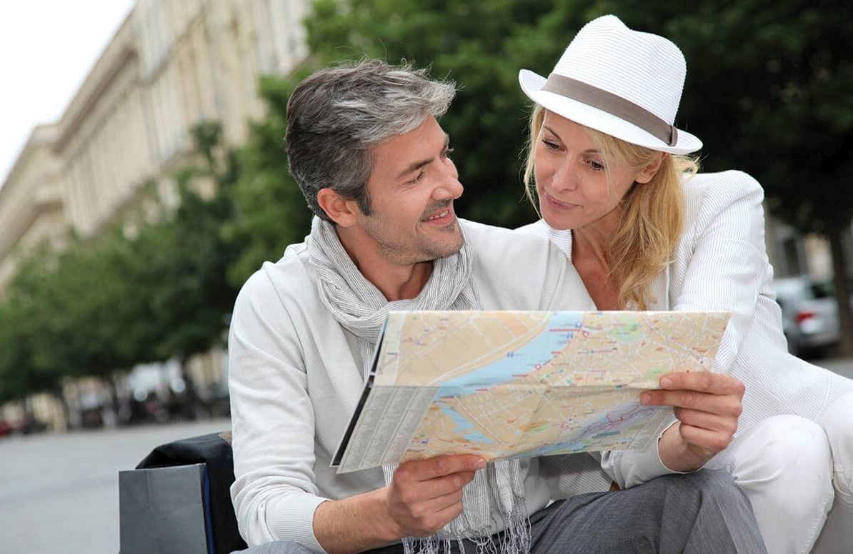Traveling couple looking at map