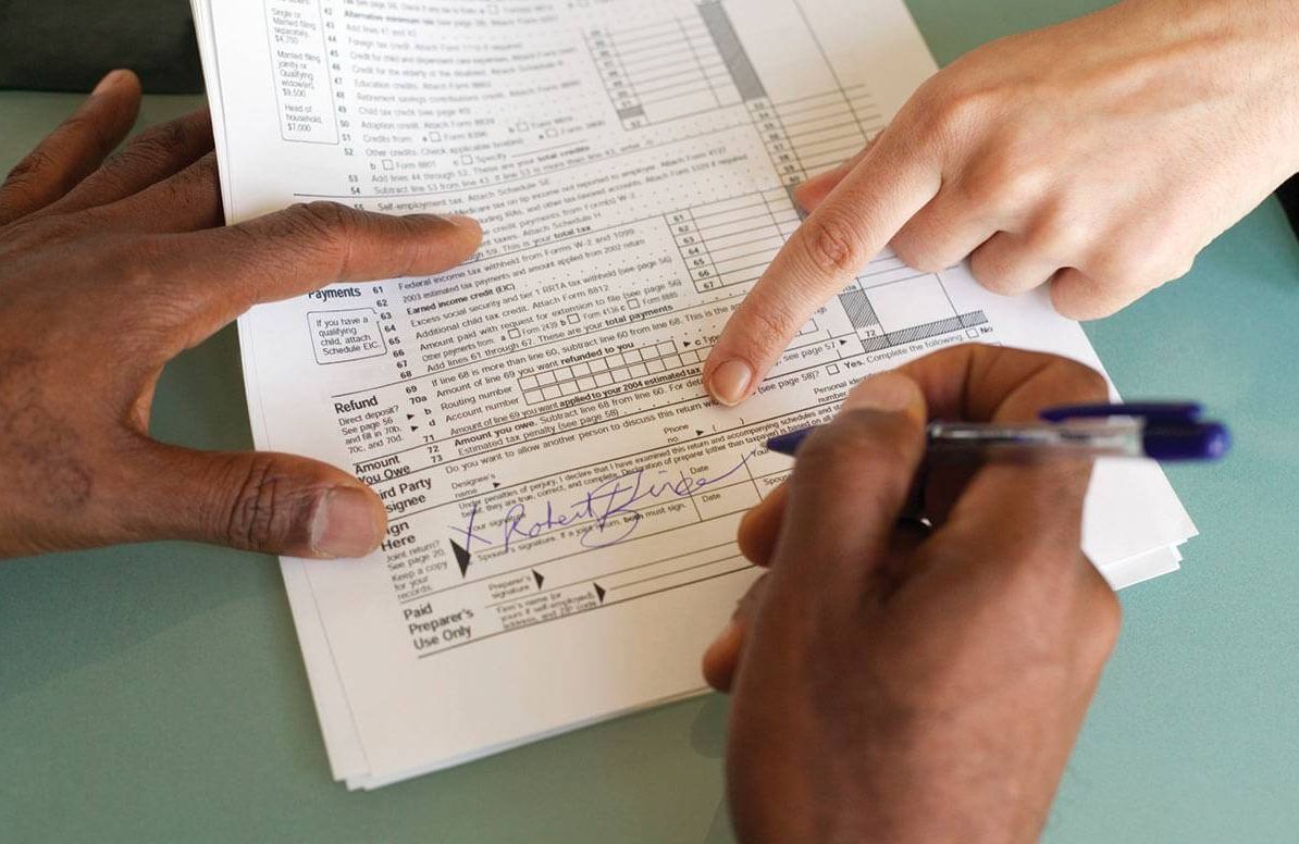 People filling out tax form