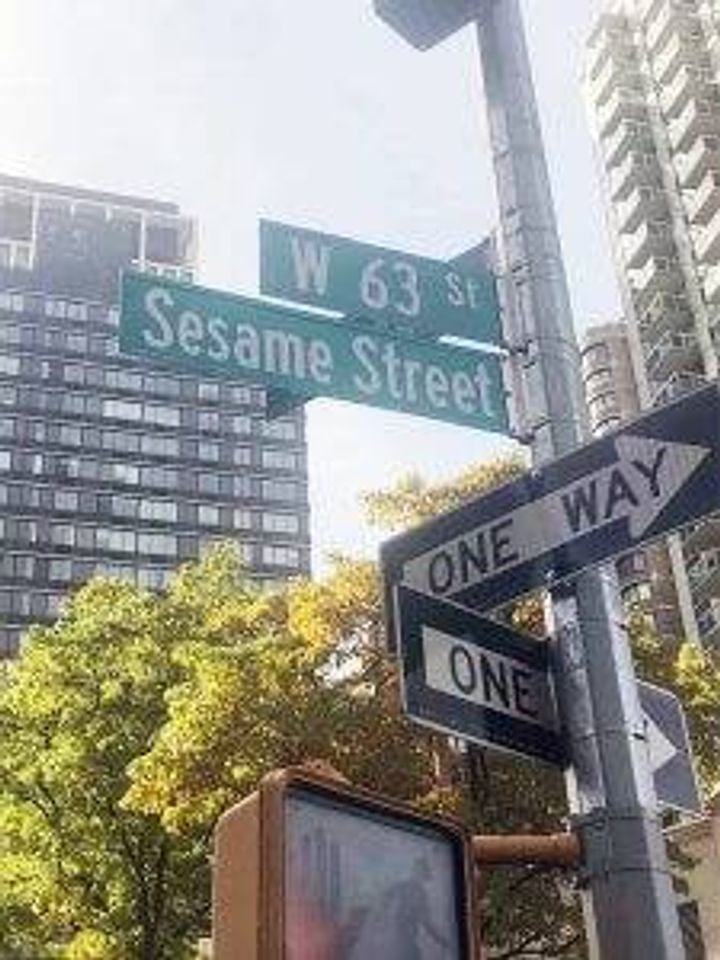 City street signs of W 63rd Street and Sesame Street