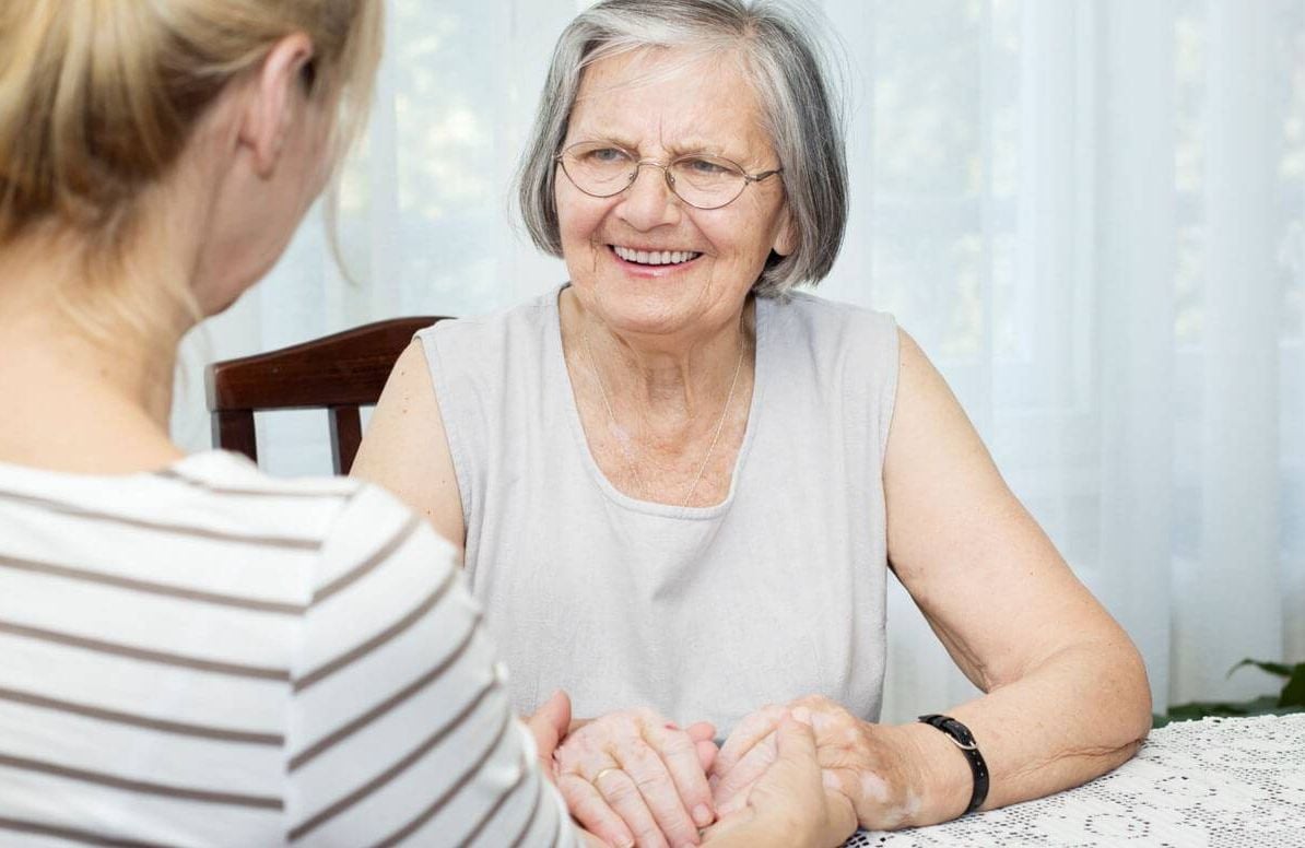 Elderly parent and daughter talking