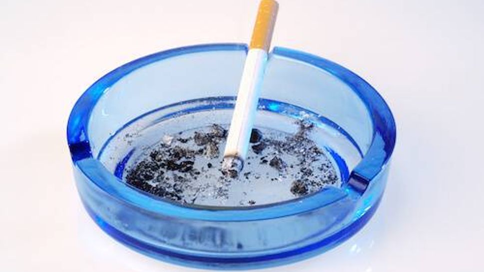 Cigarette burning in ashtray