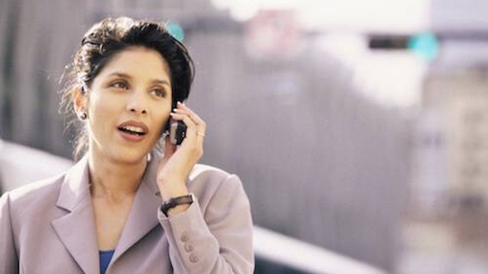 Businesswoman talking on a mobile phone smiling