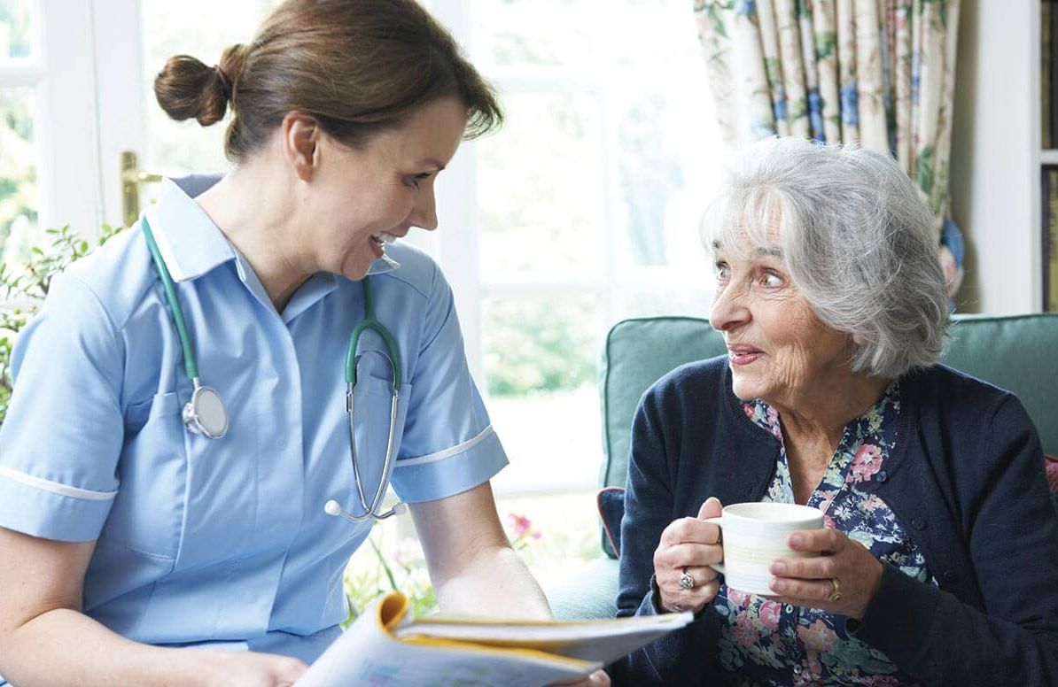 Nurse talking with woman at home