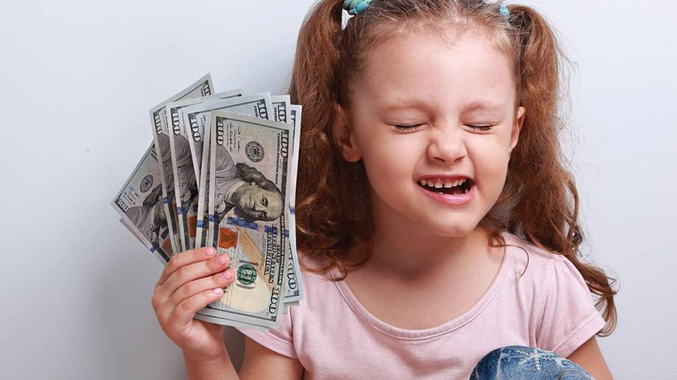 Young girl holding money