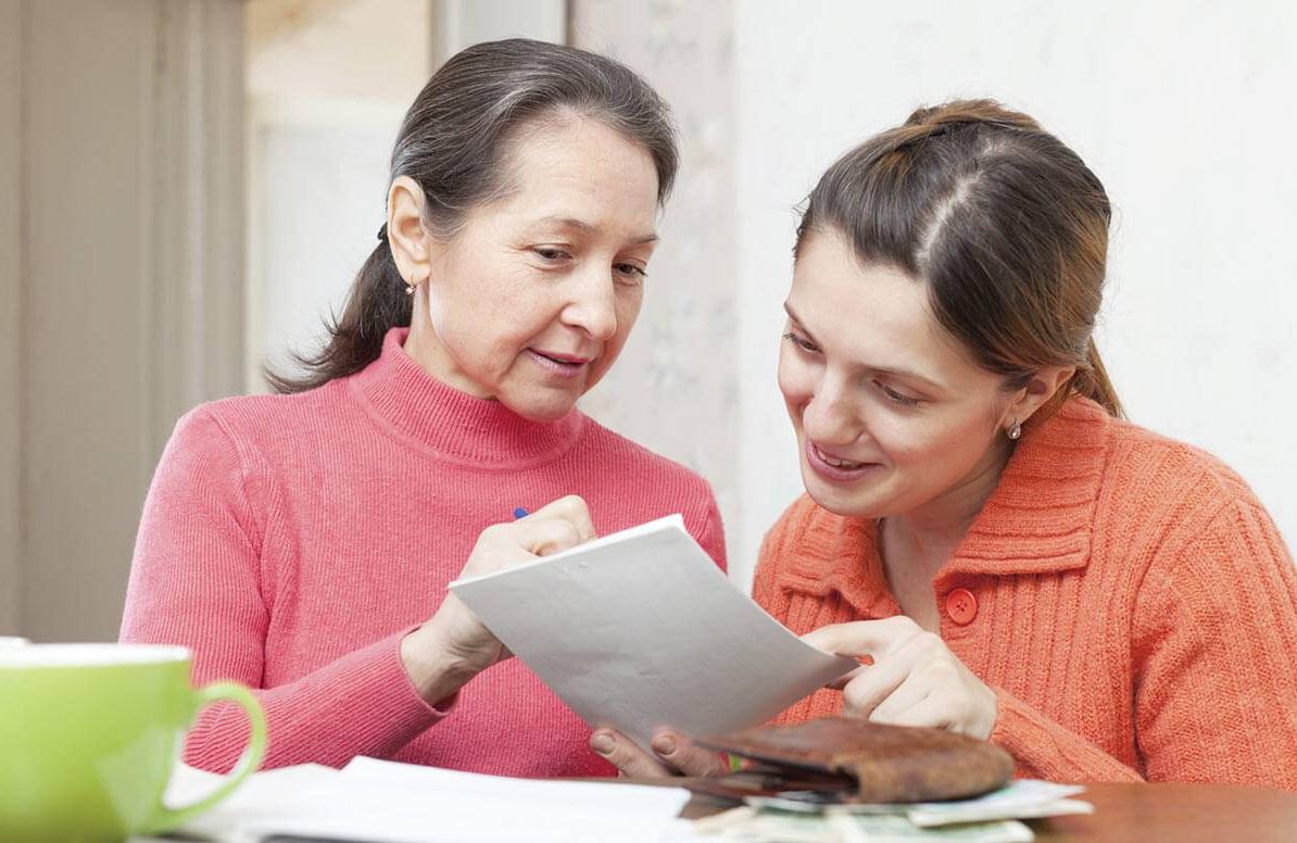 Mother and daughter reviewing finances