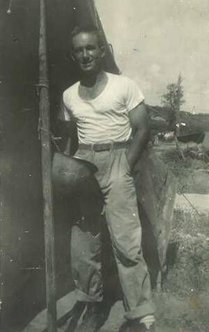 Stiller with his tent and helmet that he used for a wash basin.