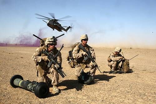 Cpl. Timothy Antolini, left, anti-tank missileman, Weapons Company, 1st Battalion, 7th Marine Regiment, and Lance Cpl. Joseph Tyler, center, anti-tank missileman, provide security as a CH-53E Super Sea Stallion helicopter lands during a mission in Helmand province, Afghanistan, April 28, 2014. The company’s mission was to disrupt Taliban forces in Larr Village and establish a presence in the area. Five days prior to the helicopter-borne mission, the company confiscated two rocket-propelled grenades in the vicinity of the village.