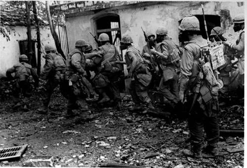 READY FOR ANYTHING--Leathernecks of "H" Co., 2nd Bn., Fifth Marines were equipped to meet any type of resistance as the combed the streets and alleys of battle-torn Hue, February 1968. Rubble from 25 days of street fighting and rocket and mortar attacks has long since been cleared away.