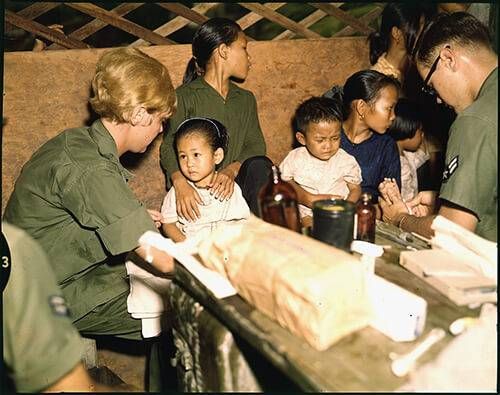 Second Lt. Kathleen M. Sullivan treats a Vietnamese child during Operation MED CAP.