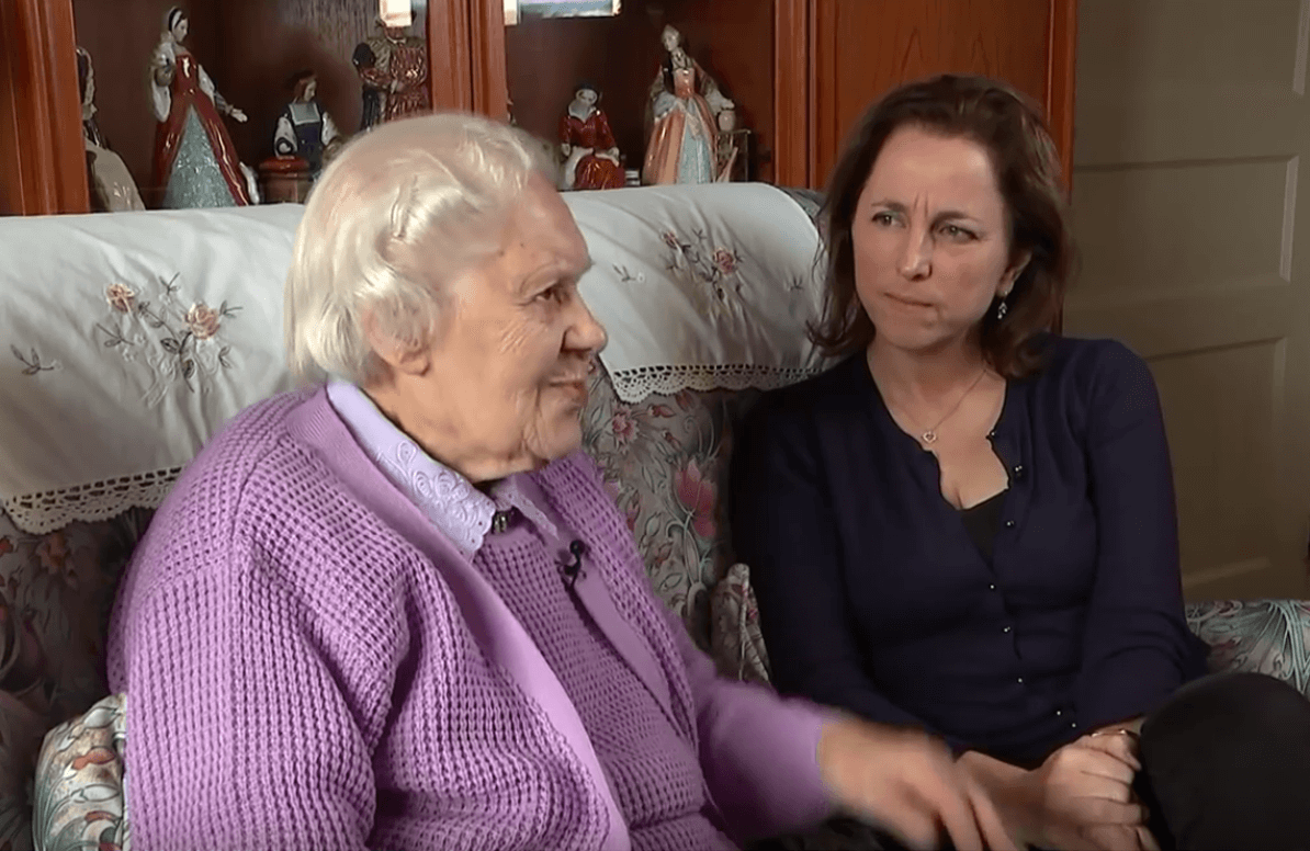 Elderly woman talking to a reporter