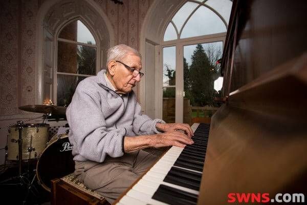 Edward Hardy plays piano in his retirement home. 