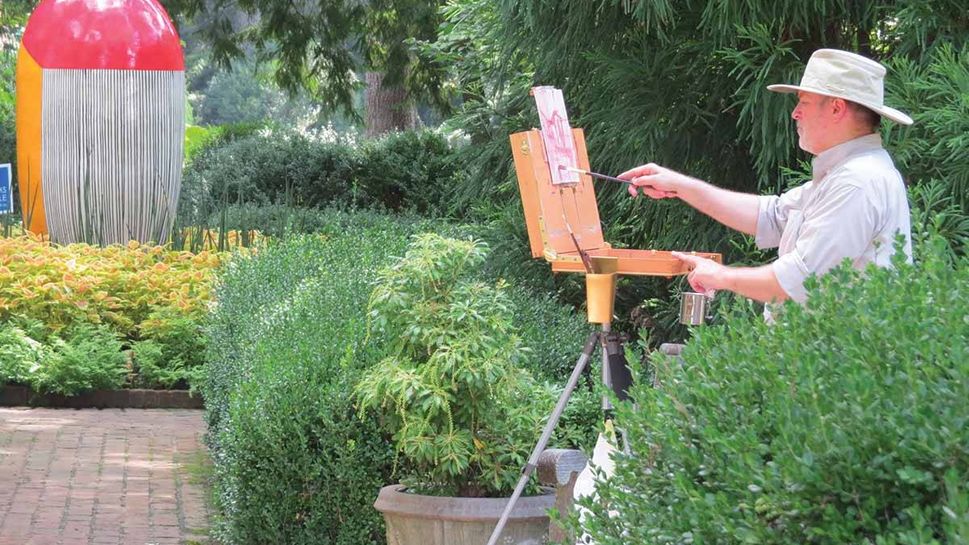 An artist paints on the grounds of the Dixon Gallery & Gardens in Memphis, Tenn.