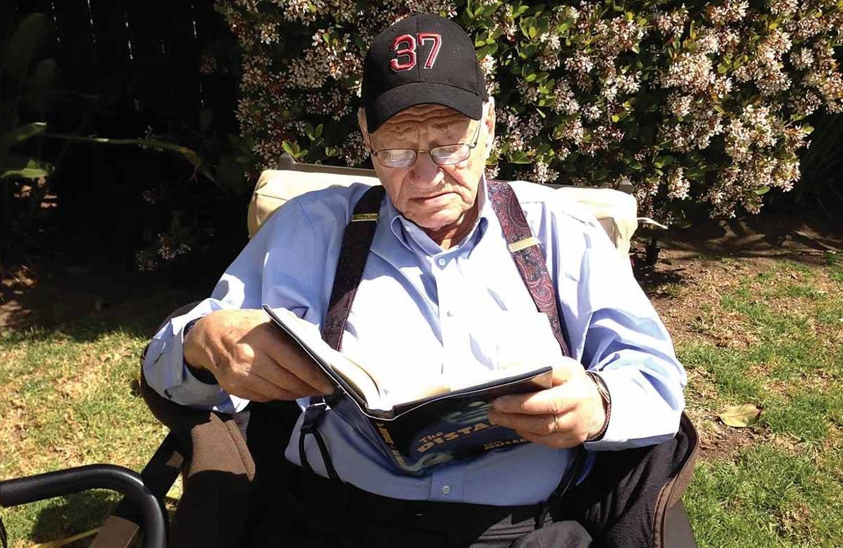Reading a crime novel in Los Angeles in 2013, ironically wearing a hat honoring the thirty-seventh President of the United States, Richard Nixon, who put Mankiewicz on the White House Enemies List.