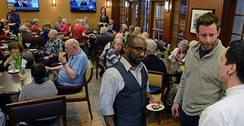 Al Baker and Ahmed Daoud interacting with Brookdale residents at a happy hour.