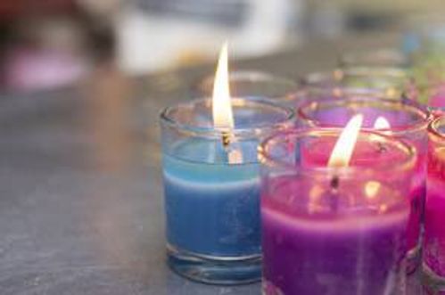 colorful burning candle in glasses