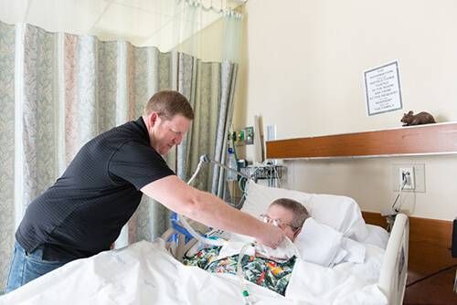 Jeremy Wilson, 40, cleans his father John Wilson’s mouth during his weekly visit at St. John’s Pleasant Valley Hospital in Camarillo on February 24, 2016.