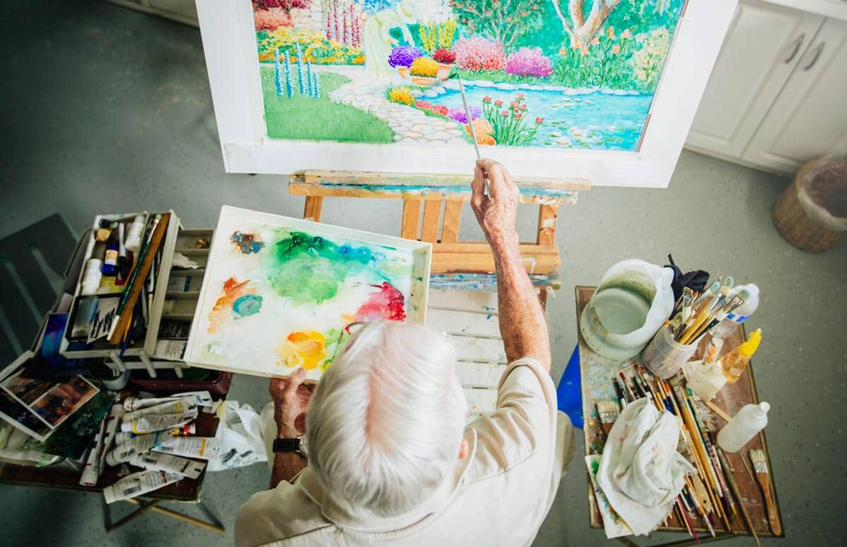 Older person painting a picture