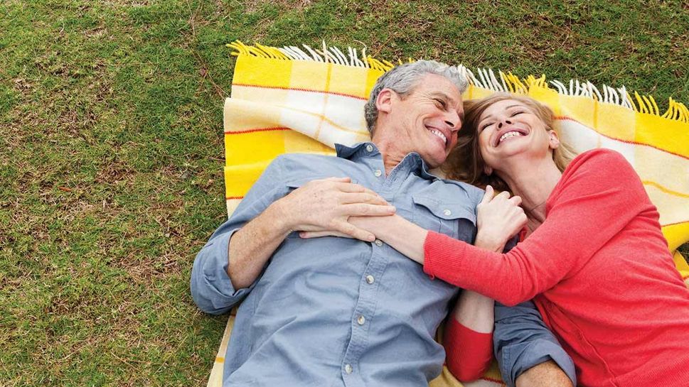 Loving couple laying on picnic blanket