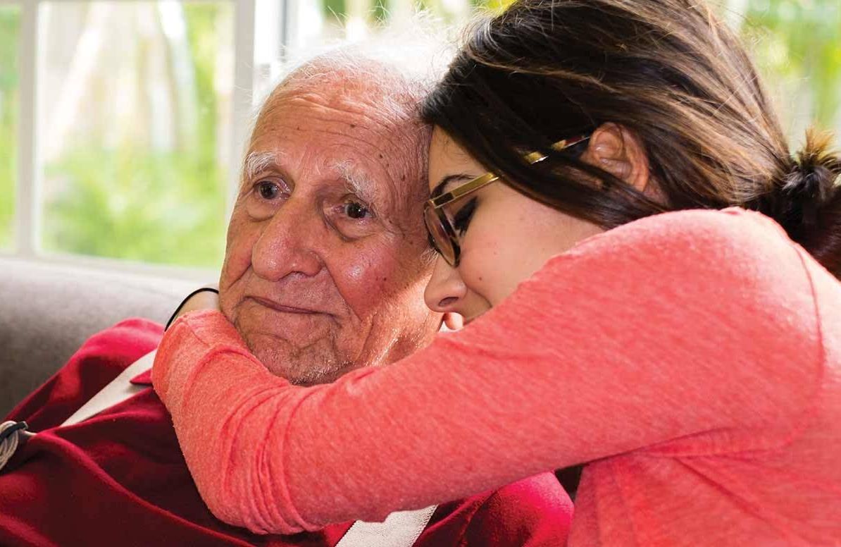 Grandchild hugging grandfather