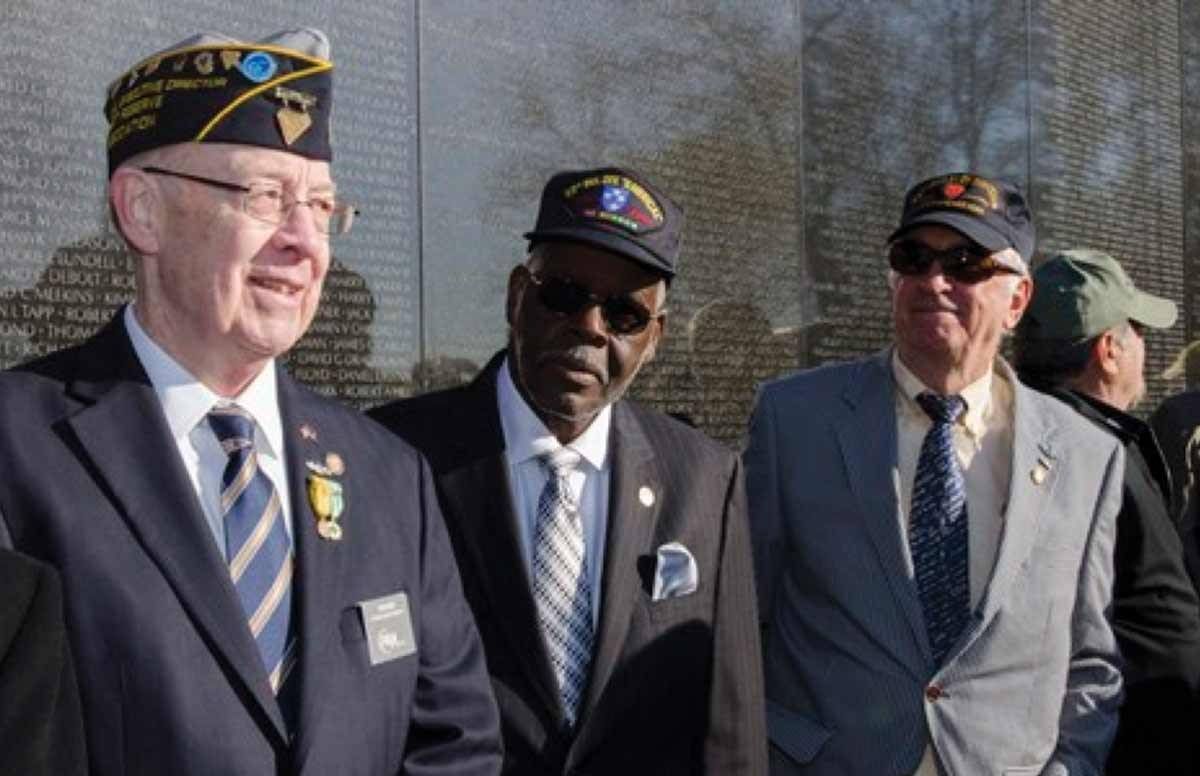 Vietnam veterans share a moment after a wreath-laying ceremony at the Vietnam Veterans Memorial in Washington DC.