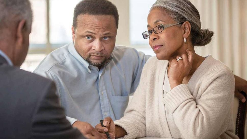 Couple talking to financial adviser